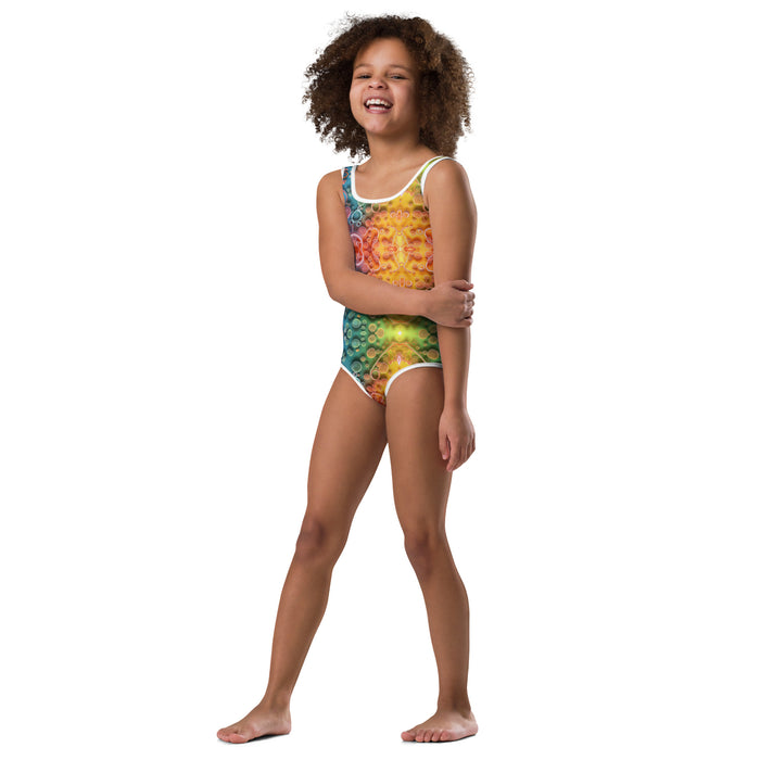 Stylish kids swimsuit mock-up with a design base on science and vibrant colors to show off a trendy beach look.